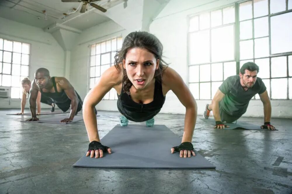 A woman is doing push ups on the floor